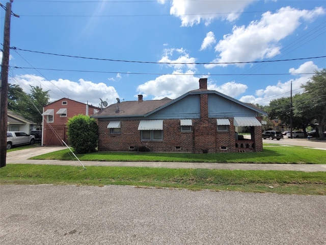 4301 Canal St, Houston, TX 77003 - view of property exterior featuring crawl space, brick siding, a chimney, and a lawn