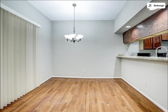 8100 Cambridge St Unit 49, Houston, TX 77054 - unfurnished dining area featuring a chandelier and light wood-type flooring