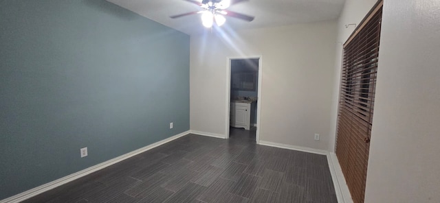 8100 Cambridge St Unit 49, Houston, TX 77054 - unfurnished bedroom featuring ceiling fan, dark wood-style floors, and connected bathroom