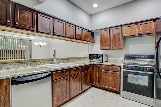 8100 Cambridge St Unit 49, Houston, TX 77054 - kitchen with appliances with stainless steel finishes, a chandelier, recessed lighting, and light stone countertops