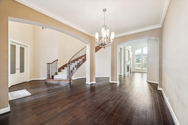 4503 Riley Way Ln, Sugar Land, TX 77479 - foyer entrance featuring arched walkways, stairway, a chandelier, hardwood / wood-style floors, and crown molding