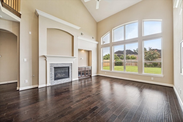 4503 Riley Way Ln, Sugar Land, TX 77479 - unfurnished living room featuring high vaulted ceiling, a fireplace, ceiling fan, dark wood-type flooring, and arched walkways