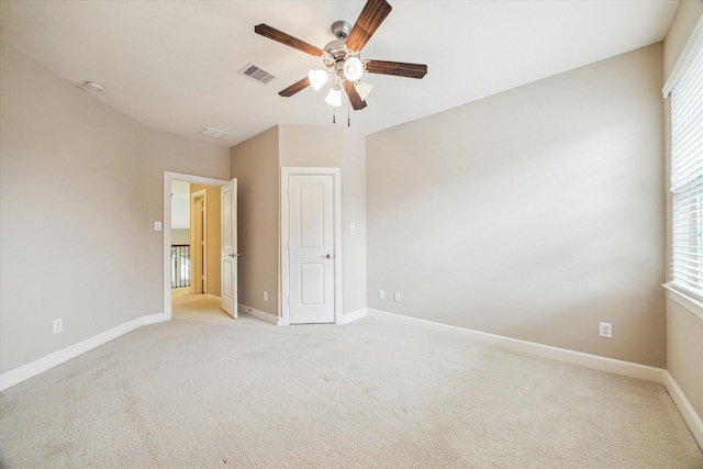 4503 Riley Way Ln, Sugar Land, TX 77479 - unfurnished bedroom with light colored carpet, multiple windows, and ceiling fan