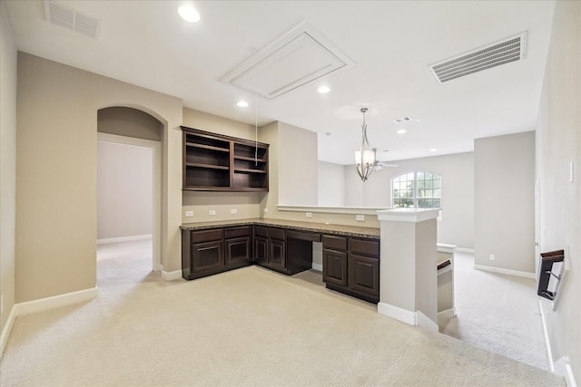 4503 Riley Way Ln, Sugar Land, TX 77479 - kitchen with light carpet, dark brown cabinets, recessed lighting, open shelves, and a peninsula