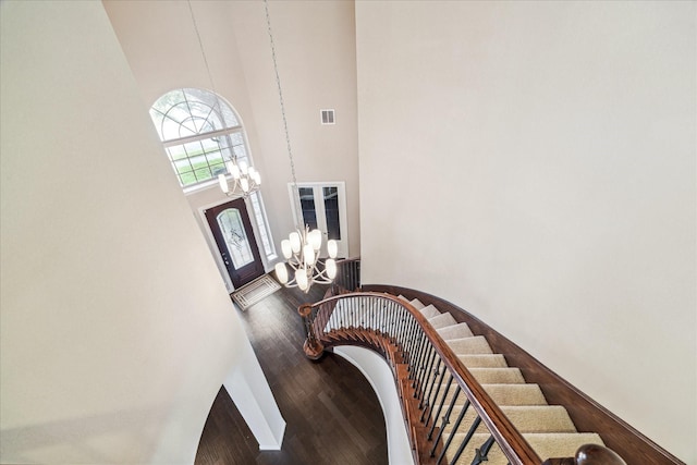 4503 Riley Way Ln, Sugar Land, TX 77479 - stairs featuring a chandelier, a towering ceiling, and wood finished floors