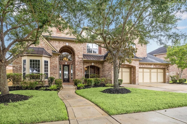 4503 Riley Way Ln, Sugar Land, TX 77479 - view of front facade with concrete driveway, brick siding, a front lawn, and a standing seam roof