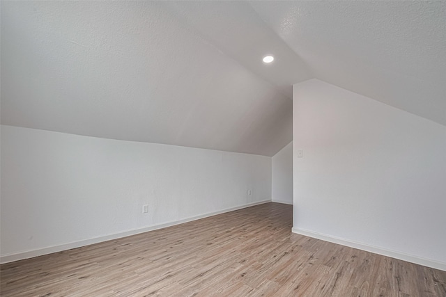 1014 13th St, Galveston, TX 77550 - additional living space featuring lofted ceiling, light wood-type flooring, recessed lighting, and a textured ceiling