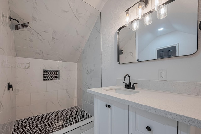 1014 13th St, Galveston, TX 77550 - bathroom featuring vanity, lofted ceiling, and tiled shower