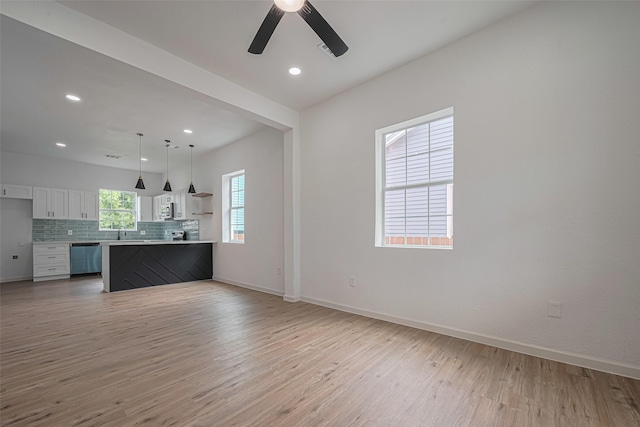 1014 13th St, Galveston, TX 77550 - unfurnished living room with light wood-type flooring, a ceiling fan, and recessed lighting
