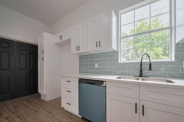 1014 13th St, Galveston, TX 77550 - kitchen featuring dishwashing machine, white cabinets, decorative backsplash, and wood finished floors