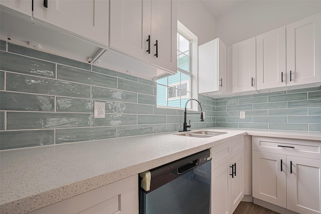 1014 13th St, Galveston, TX 77550 - kitchen featuring dishwasher, white cabinets, light stone counters, and backsplash