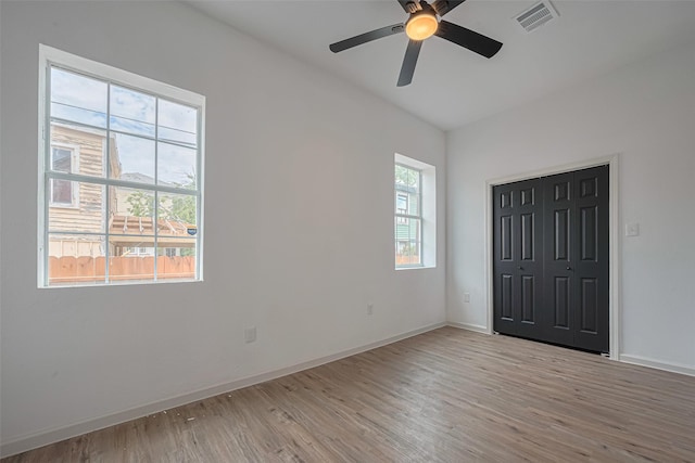 1014 13th St, Galveston, TX 77550 - unfurnished bedroom with light wood-style floors, ceiling fan, and a closet