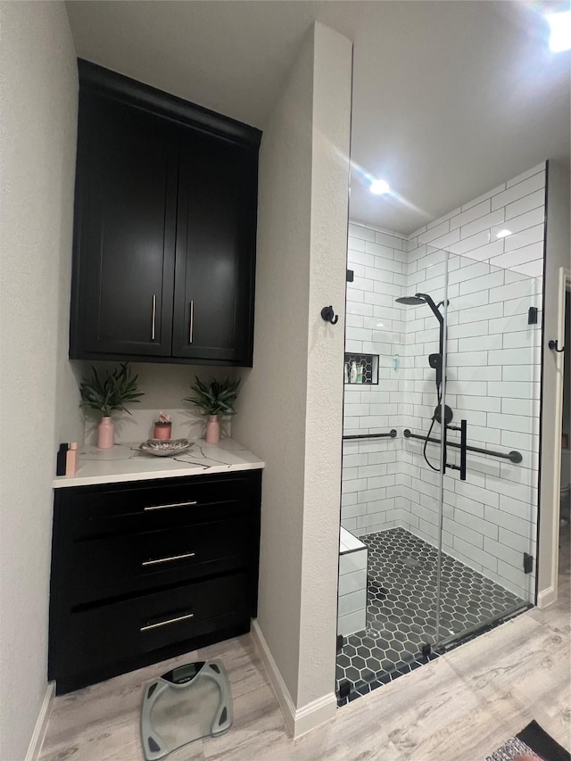 11577 Gingerland Dr, Conroe, TX 77304 - full bathroom with a stall shower and wood finished floors