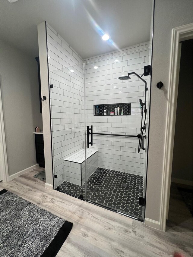11577 Gingerland Dr, Conroe, TX 77304 - bathroom with wood finished floors, a stall shower, and a sauna / steam room