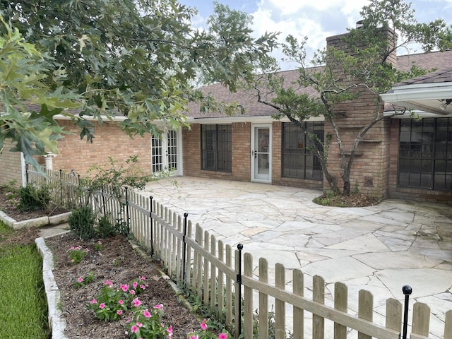 3419 Willowrun Dr, Montgomery, TX 77356 - back of property featuring brick siding, a patio, a shingled roof, french doors, and a chimney