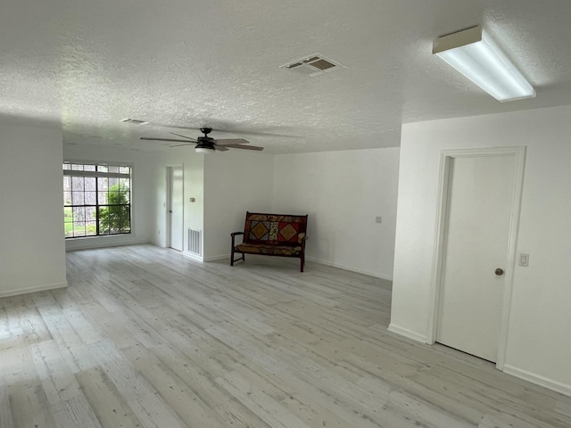 3419 Willowrun Dr, Montgomery, TX 77356 - unfurnished room featuring light wood-style flooring, ceiling fan, and a textured ceiling