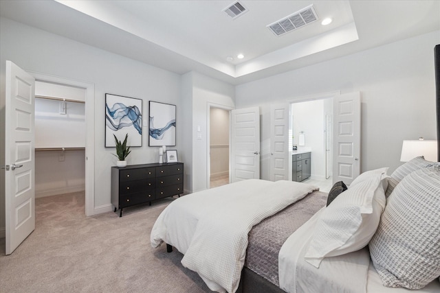 1804 Elysian St, Houston, TX 77026 - bedroom featuring light colored carpet, a spacious closet, recessed lighting, ensuite bathroom, and a raised ceiling
