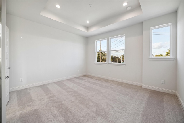 1812 Elysian St, Houston, TX 77026 - empty room featuring recessed lighting, a tray ceiling, light colored carpet, and a smoke detector