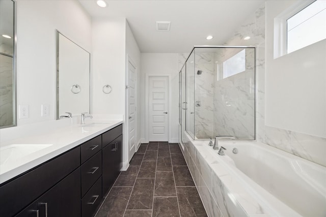 1812 Elysian St, Houston, TX 77026 - full bathroom with a garden tub, a marble finish shower, double vanity, marble look tiles, and recessed lighting