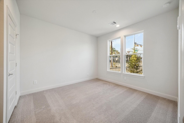1812 Elysian St, Houston, TX 77026 - empty room featuring a smoke detector, light carpet, and recessed lighting