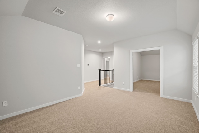 15215 Statice Trl, Houston, TX 77044 - spare room featuring lofted ceiling, light carpet, and recessed lighting
