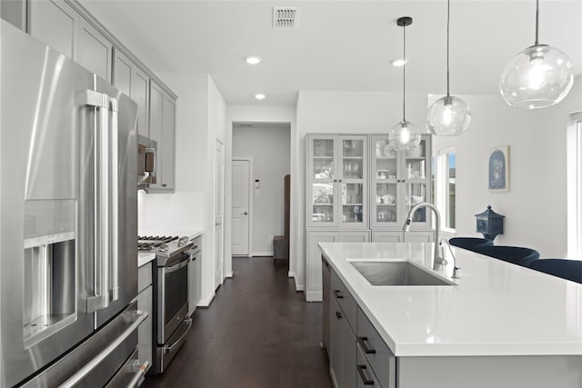 8814 Riverton Ridge Rd, Cypress, TX 77433 - kitchen with stainless steel appliances, gray cabinetry, light countertops, recessed lighting, and dark wood-style flooring