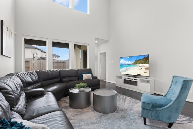 8814 Riverton Ridge Rd, Cypress, TX 77433 - living area with healthy amount of natural light, dark wood-style floors, and a towering ceiling