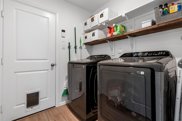 19919 Epirus Shores Dr, Hockley, TX 77447 - laundry room featuring washing machine and clothes dryer and light wood-style floors