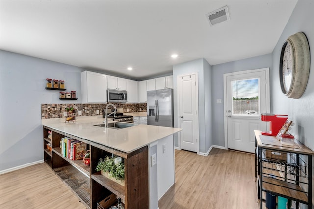 19919 Epirus Shores Dr, Hockley, TX 77447 - kitchen featuring open shelves, appliances with stainless steel finishes, light wood finished floors, light countertops, and recessed lighting