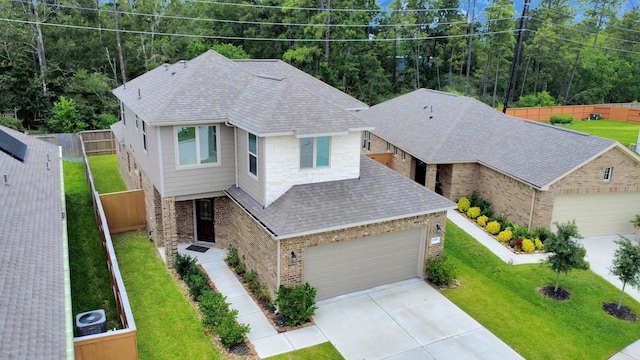 12306 Belhaven Terrace Dr, Houston, TX 77044 - view of front of property featuring brick siding, roof with shingles, and driveway