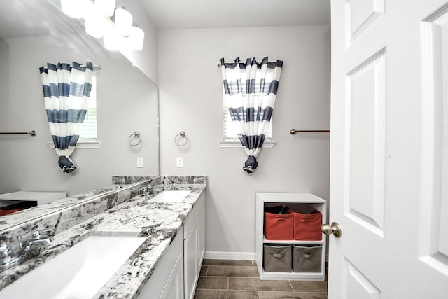 12306 Belhaven Terrace Dr, Houston, TX 77044 - full bathroom featuring double vanity and baseboards