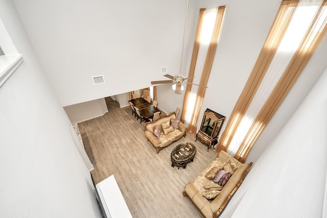 12306 Belhaven Terrace Dr, Houston, TX 77044 - living room featuring a high ceiling, plenty of natural light, wood finished floors, and ceiling fan