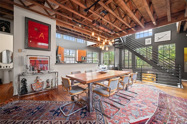 2614 Yoakum Blvd, Houston, TX 77006 - dining space with hardwood / wood-style flooring, plenty of natural light, a wood ceiling with exposed beams, and a towering ceiling