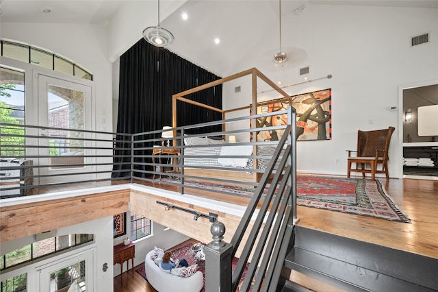 2614 Yoakum Blvd, Houston, TX 77006 - staircase featuring high vaulted ceiling and wood finished floors