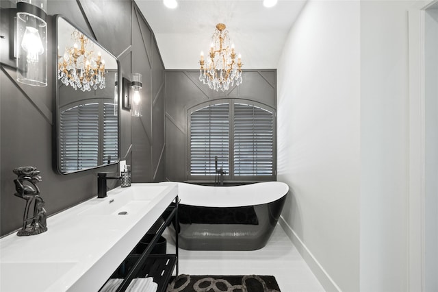 2614 Yoakum Blvd, Houston, TX 77006 - bathroom featuring a chandelier, a freestanding bath, double vanity, and recessed lighting