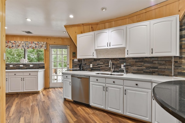 12901 E Barcelona, Galveston, TX 77554 - kitchen with stainless steel dishwasher, backsplash, white cabinetry, wood finished floors, and recessed lighting