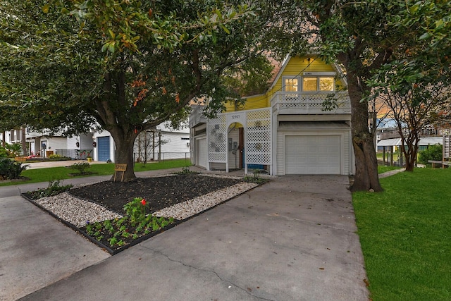 12901 E Barcelona, Galveston, TX 77554 - view of front of property with a front yard, concrete driveway, and a garage