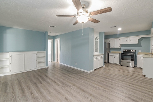 3735 Woodpeckers Grv, Cleveland, TX 77328 - kitchen with stainless steel appliances, open floor plan, light countertops, a ceiling fan, and a textured ceiling