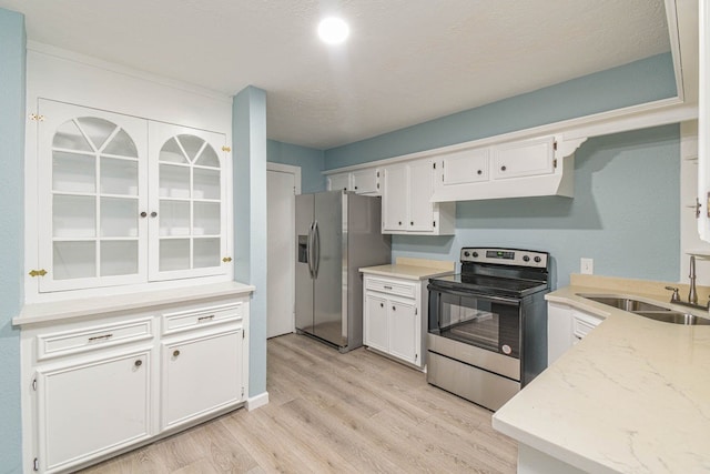 3735 Woodpeckers Grv, Cleveland, TX 77328 - kitchen with appliances with stainless steel finishes, under cabinet range hood, light wood-style flooring, and white cabinets