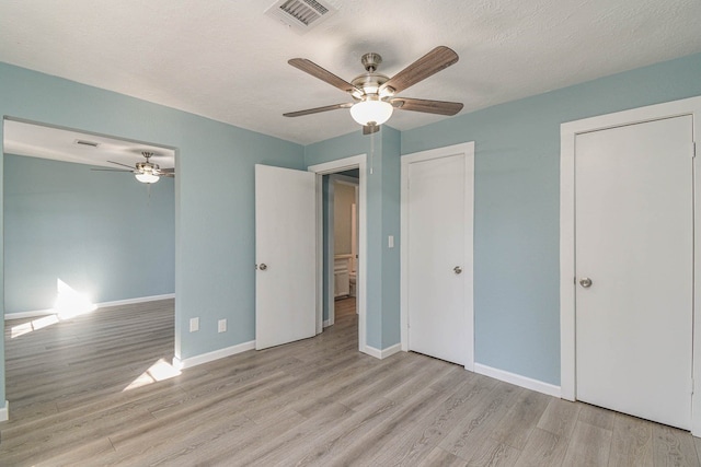 3735 Woodpeckers Grv, Cleveland, TX 77328 - unfurnished bedroom with wood finished floors, ceiling fan, and a textured ceiling
