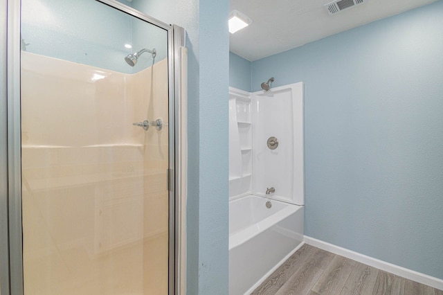 3735 Woodpeckers Grv, Cleveland, TX 77328 - full bathroom with wood finished floors and bathing tub / shower combination