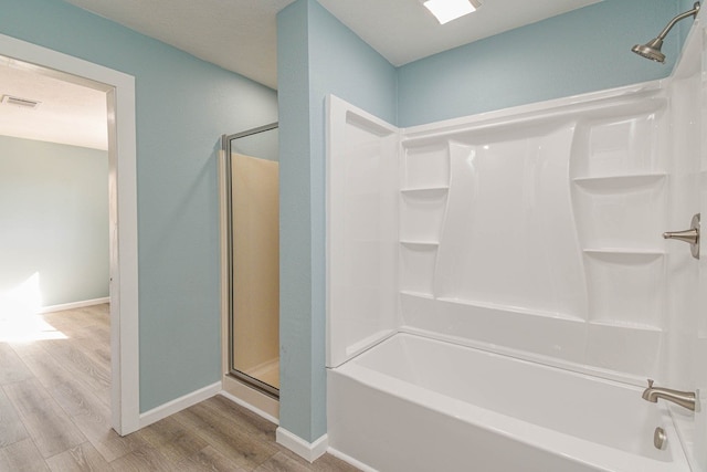 3735 Woodpeckers Grv, Cleveland, TX 77328 - full bathroom featuring wood finished floors and shower / tub combination