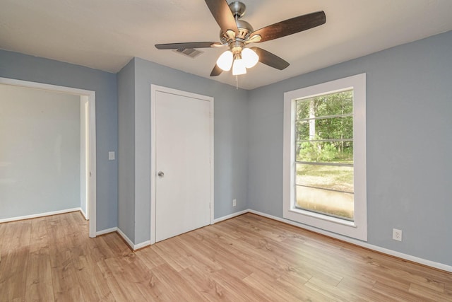 3735 Woodpeckers Grv, Cleveland, TX 77328 - unfurnished bedroom featuring light wood-style flooring, a ceiling fan, and a closet