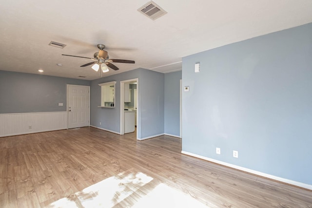 3735 Woodpeckers Grv, Cleveland, TX 77328 - unfurnished room with light wood-style flooring, ceiling fan, and wainscoting