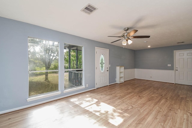 3735 Woodpeckers Grv, Cleveland, TX 77328 - entryway featuring wood finished floors, wainscoting, and ceiling fan