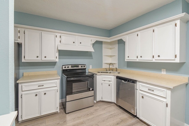 3735 Woodpeckers Grv, Cleveland, TX 77328 - kitchen with stainless steel appliances, under cabinet range hood, light wood finished floors, and light countertops