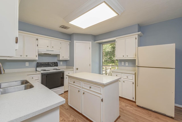 3735 Woodpeckers Grv, Cleveland, TX 77328 - kitchen featuring white appliances, under cabinet range hood, white cabinetry, light wood-type flooring, and light countertops