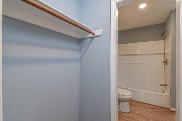 3735 Woodpeckers Grv, Cleveland, TX 77328 - bathroom featuring wood finished floors and shower / tub combination
