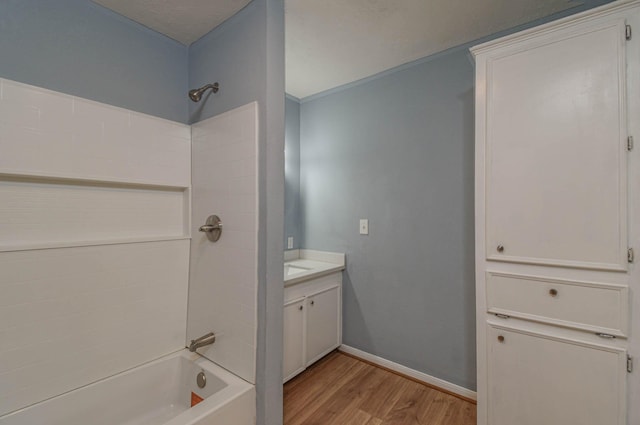 3735 Woodpeckers Grv, Cleveland, TX 77328 - bathroom featuring wood finished floors, shower / bathtub combination, and vanity