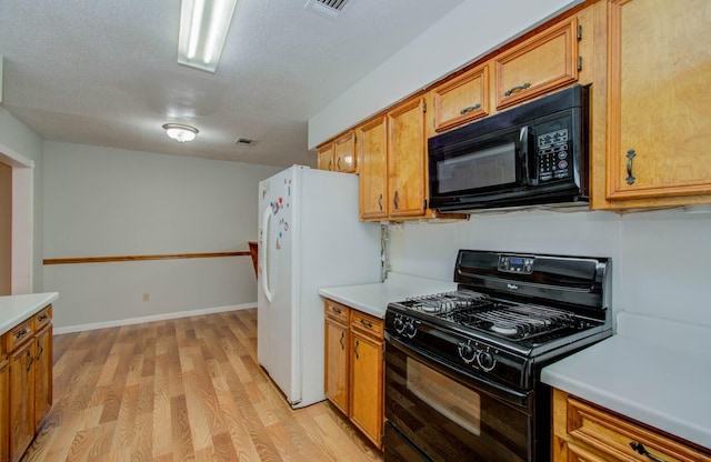 10131 Tangiers Rd, Houston, TX 77041 - kitchen featuring black appliances, light wood-type flooring, light countertops, brown cabinetry, and a textured ceiling